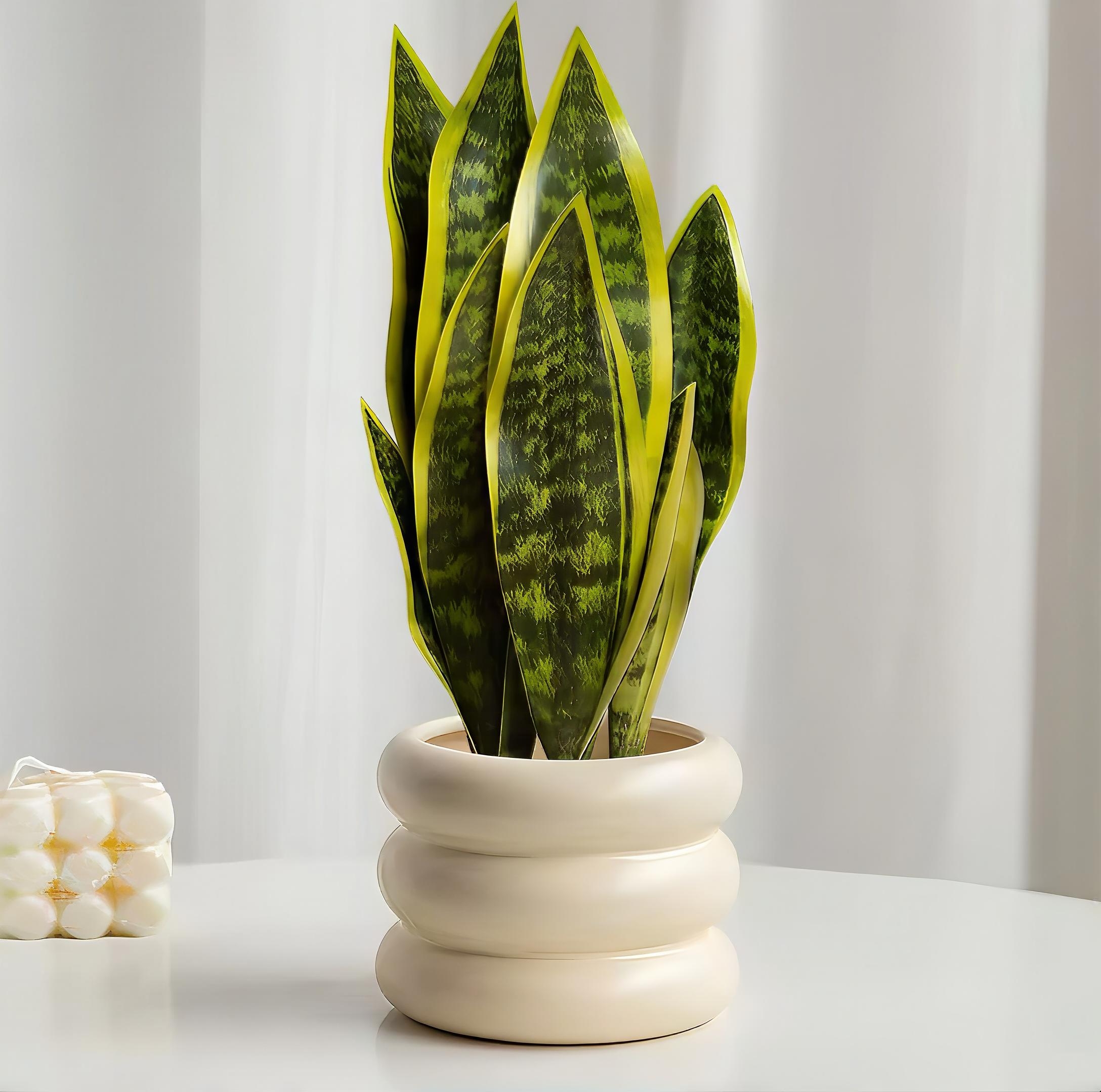 An artificial snake plant with vibrant green and yellow-edged leaves sitting in a wavy, cream-colored ceramic pot.